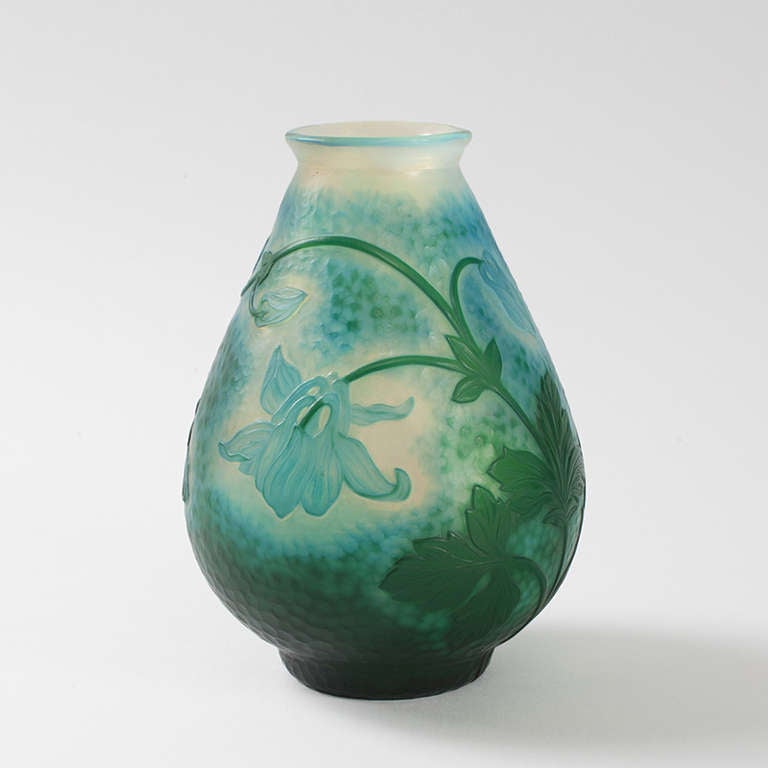 A French Art Nouveau wheel carved vase by Daum, featuring light blue columbine flowers with dark green stems and leaves against a blue and green ground. Circa 1900.

Signed, “Daum Nancy” and marked with the Croix de Lorraine. 

A vase with