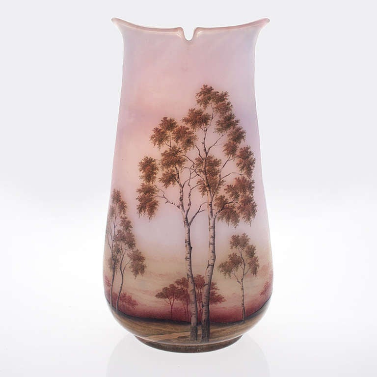 A French Art Nouveau vase by Daum featuring pink glass with an etched and enameled Spring landscape motif. Circa 1900.

Signed, 