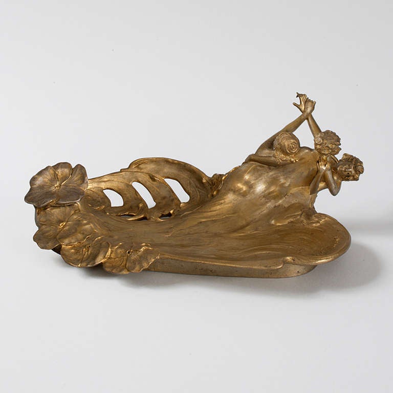 A French Art Nouveau gilt patinated bronze Inkwell by Georges Flamand. This piece features three entwined maidens amidst water and flowers.  Circa 1900.  Pictured in: Dynamic Beauty: Sculpture of Art Nouveau Paris, by Macklowe Gallery, The Studley