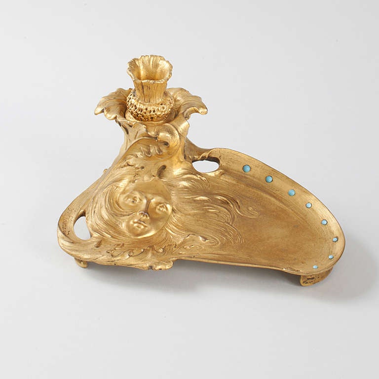 A French Art Nouveau gilt bronze tray and inkwell by Geroges  Flamand, with a woman's face set in leaves with powder blue turquoise cabochon decorations. The inkwell is shaped like a flower. Titled 