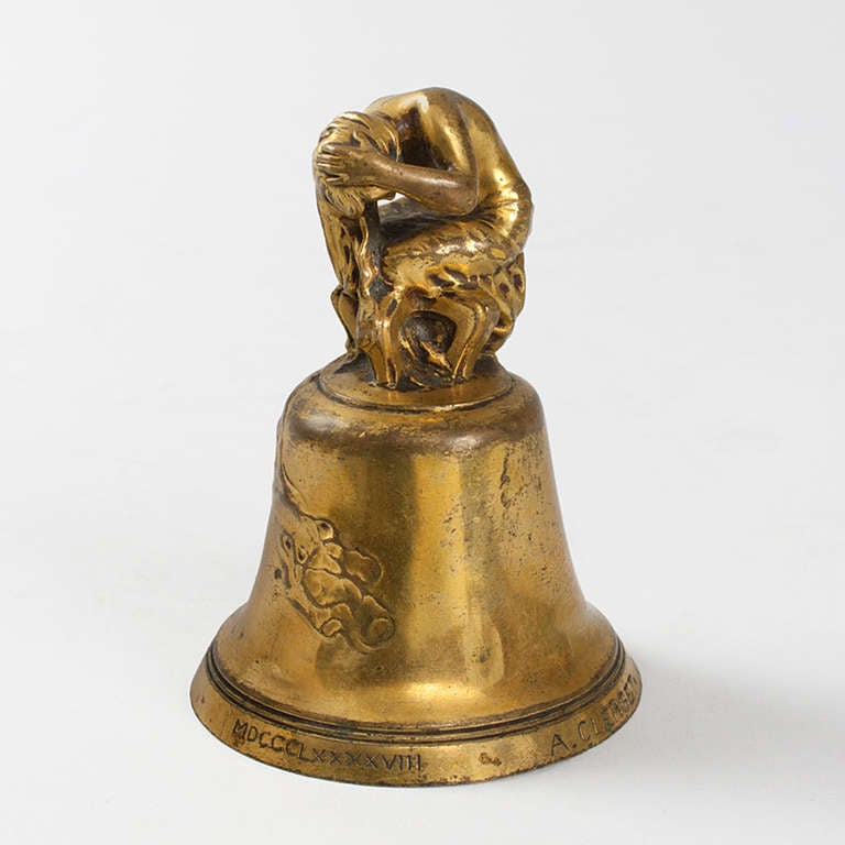 A French Art Nouveau gilt bronze dinner bell by Alexandre Clerget (1856-1931). A nude female bather is seated atop the bell, forming the handle.  Her disheveled hair and drapery hang downwards and drape onto the surface of the bell. Circa 1900.
