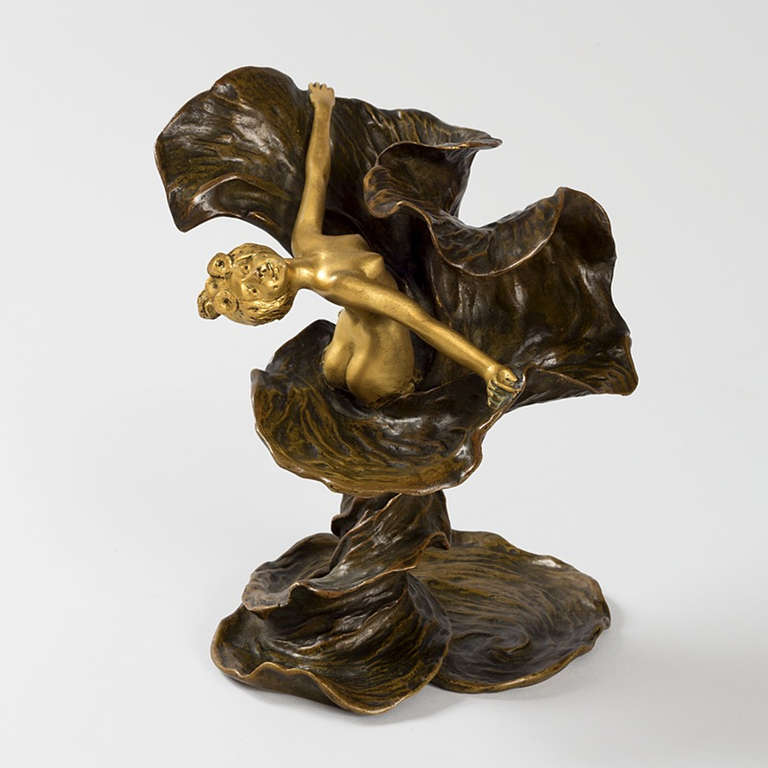 A French Art Nouveau gilt and dark patinated bronze sculpture of Loïe Fuller by Louis Chalon. The nude gilt bronze woman with flowers in her hair is surrounded by billowing, swirling patinated bronze drapery. Circa 1894.

Stamped with the Louchet