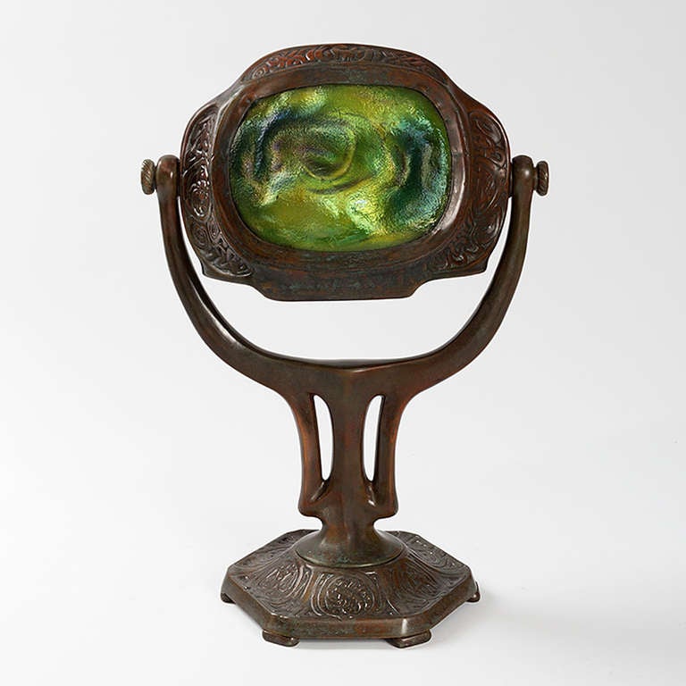 Tiffany Studios zodiac turtleback desk lamp in dark patinated bronze with two dichromatic blue/green turtleback tiles. The head swivels revealing one turtleback tile in the front and one in the back. Circa 1905.

A similar lamp is pictured in: