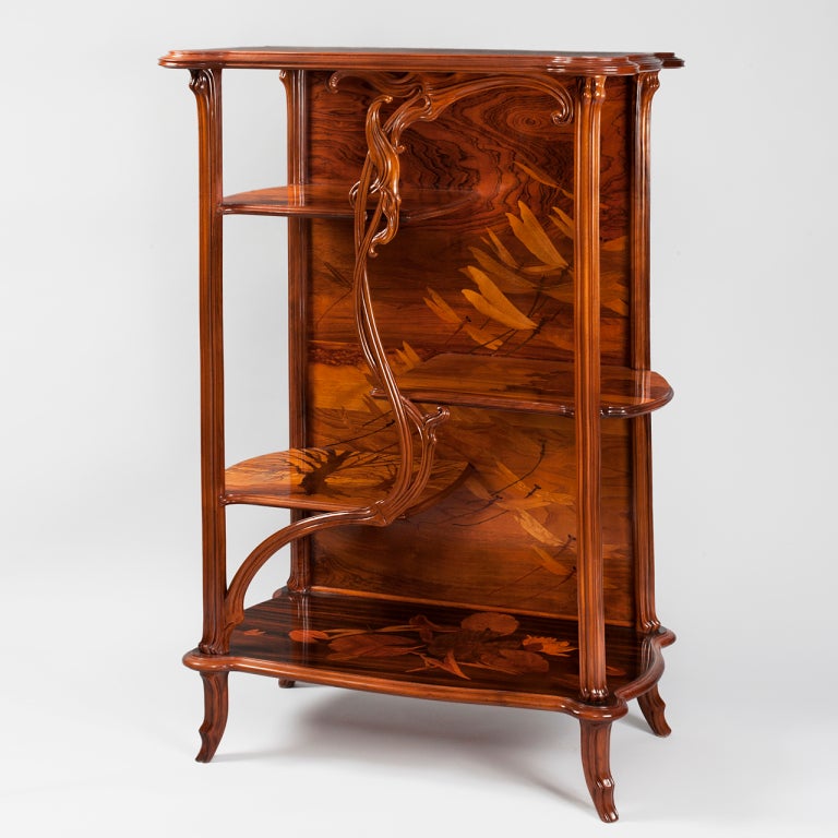 A French Art Nouveau etagere by Emile Gallé with dragonflies in marquetry on the shelves and back panel and additional organic carved forms comprising the structural elements of the piece. (MG Inventory # F14635)

Provenance:  Collection of