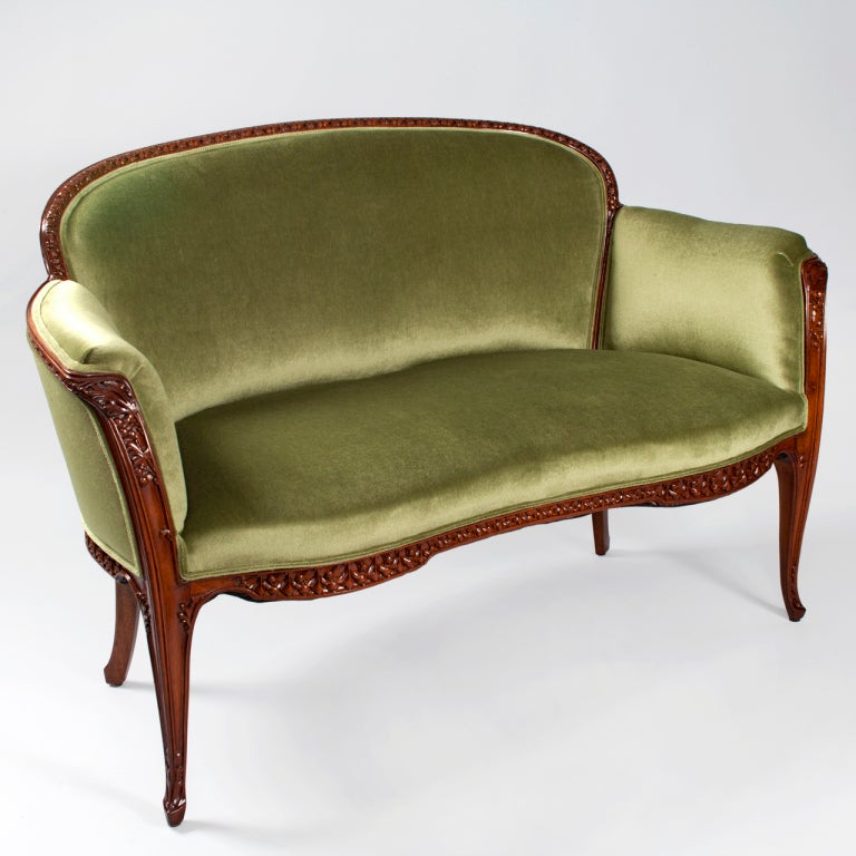 A French Art Nouveau salon suite, consisting of a settee and two armchairs, in the 