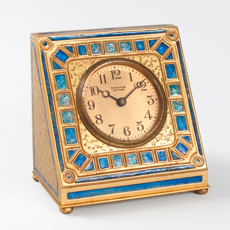 A Tiffany Studios New York gilt bronze and enamel clock. Face signed  Tiffany & Co. New York. A similar clock is pictured in Tiffany Desk Sets, by William R. Holland, Atgen, PA: Schiffer Books, 2008, page 194, figure 16-18. (MG # T14927)