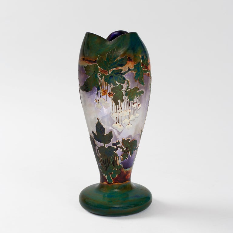 A Belgian Art Nouveau acid-etched cameo vase designed by Desiré and Henri Muller and executed at Val Saint Lambert, featuring flowering vines with hanging blossoms against a sky-blue ground. Val Saint Lambert was famous for perfecting the technique