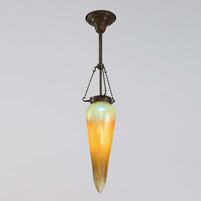 A Tiffany Studios New York Stalactite chandelier with iridescent gold pulled decoration on an iridescent white, gold and silver ground.  Circa 1900.

A similar shade is pictured in: Tiffany Lamps and Metalware: An illustrated reference to over