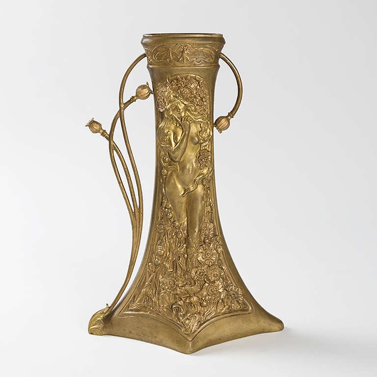 French Art Nouveau vase by Charles Korschann in gilt-bronze. The vase has a diamond shaped base that tapers to a narrow rounded top, where it intersects with swirling stems and flower buds that form the handle, and features sculpted decoration in