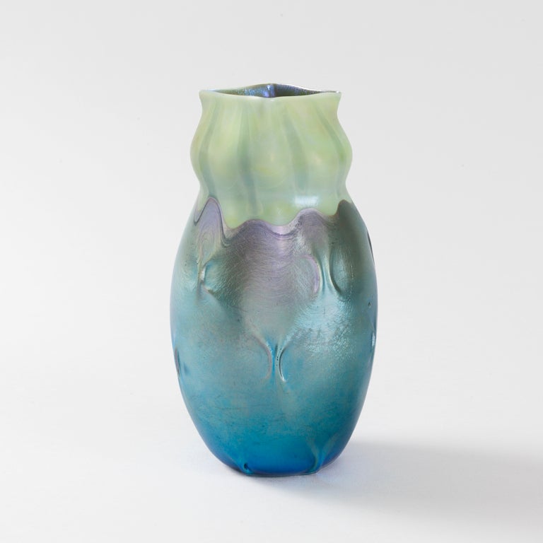 A Tiffany Studios New York decorated blue favrile glass vase.

Favrile is the trade name Tiffany gave to his blown art glass. The name derives from the Latin word fabrilis, meaning 