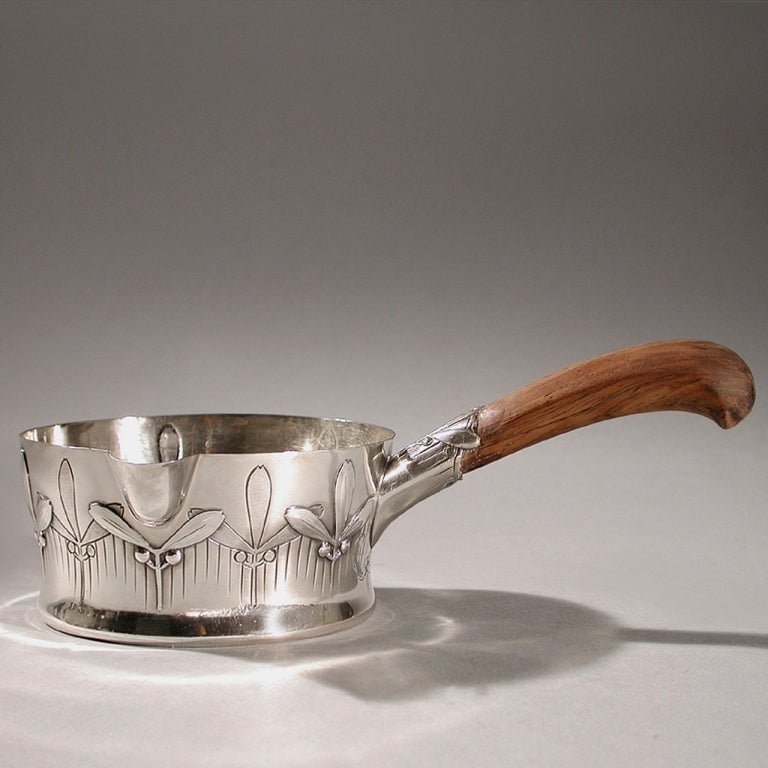 A French Art Nouveau silver ladle by Antoine Cardeilhac, featuring a mistletoe motif with, a wood handle. Signed, 