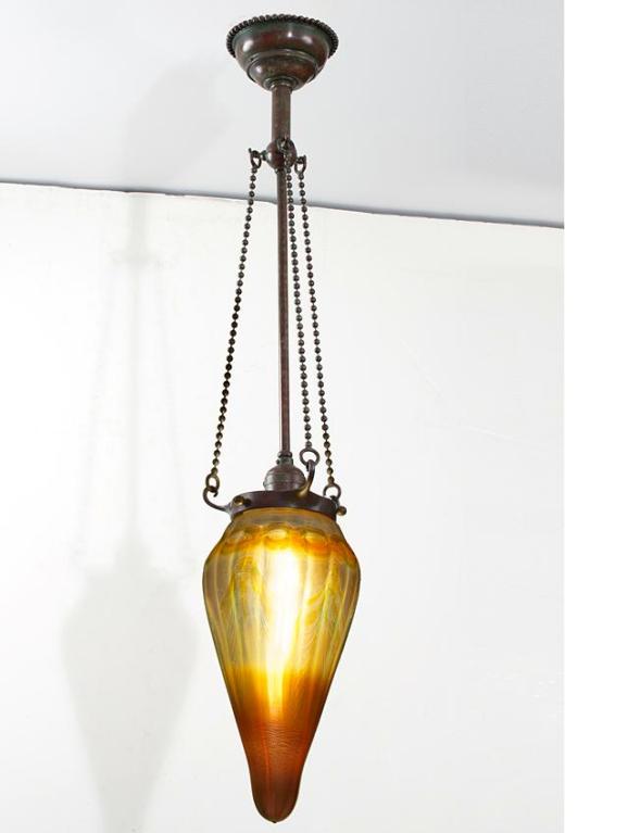 A Tiffany Studios New York golden favrile stalactite chandelier. A similar fixture is pictured in: Tiffany Lamps and  Metalware: An illustrated reference to over 2000 models, by Alastair Duncan, Woodbridge: Suffolk: Antique Collectors' Club, 1988,