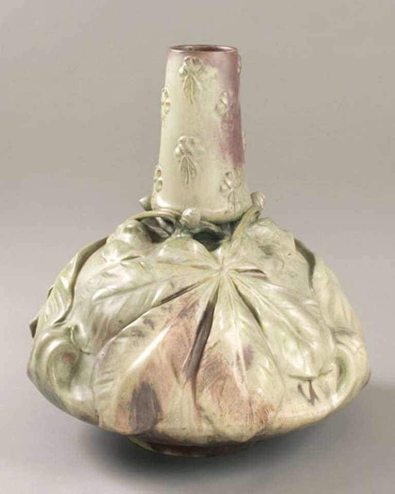 A French Art Nouveau ceramic vase designed by Ernest Bussière and produced by Keller et Guérin, modeled foliate motif in high relief with green and purple glaze, circa 1900.
Signed 