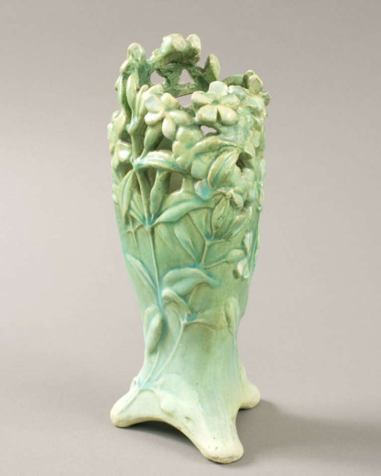 A French Art Nouveau ceramic vase by Edmond Lachenal, featuring a stylistic depiction of leaves and vines with intricate piercing and carving in a graduated light green to green glaze.  Circa 1898.

Signed, 