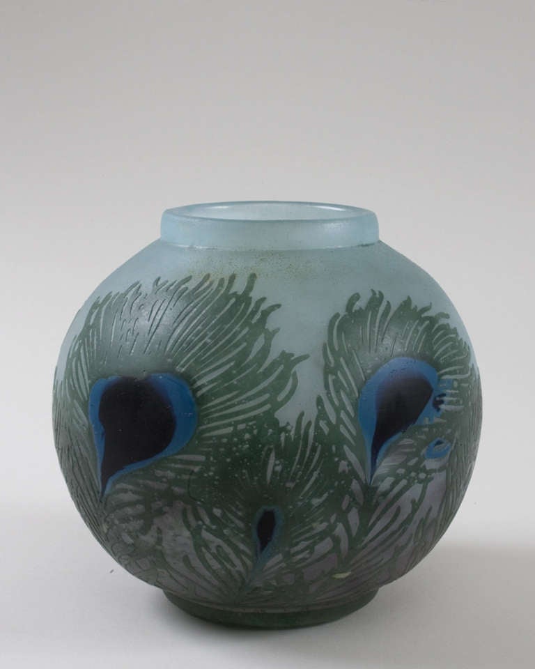A French Art Nouveau wheel-carved cameo glass vase by Daum, featuring a raised green peacock feather decoration with two-toned blue centers, against a blue and sea-green ground.  Circa 1900.

Signed, 