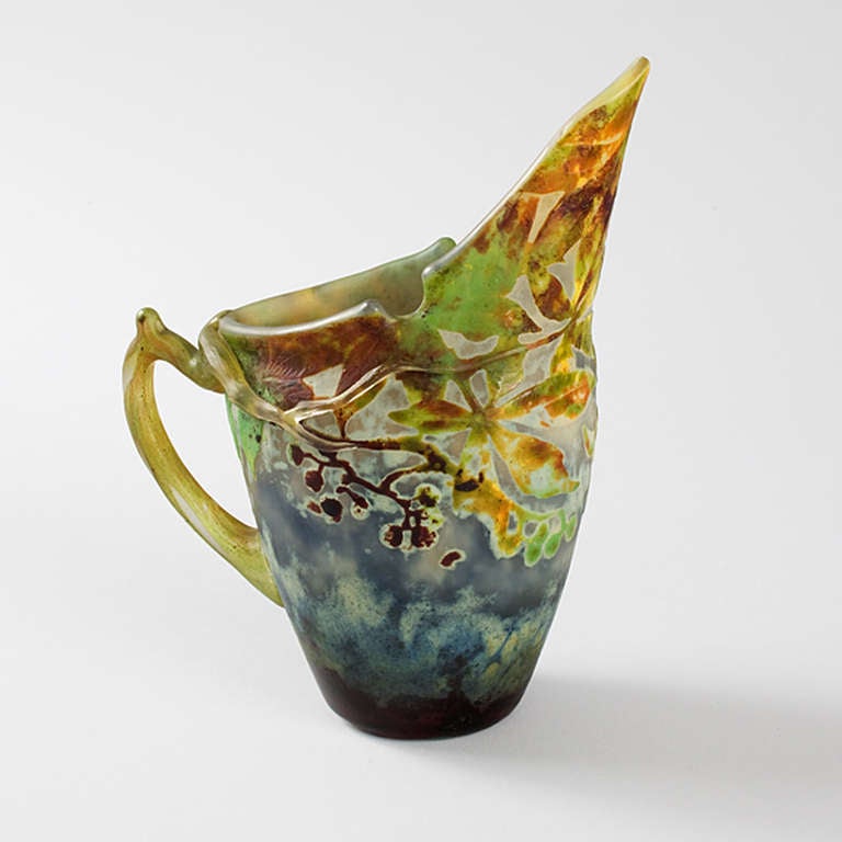 A French Art Nouveau pitcher by Daum depicting leaves and vines against a blue ground. Circa 1900.

Signed, 