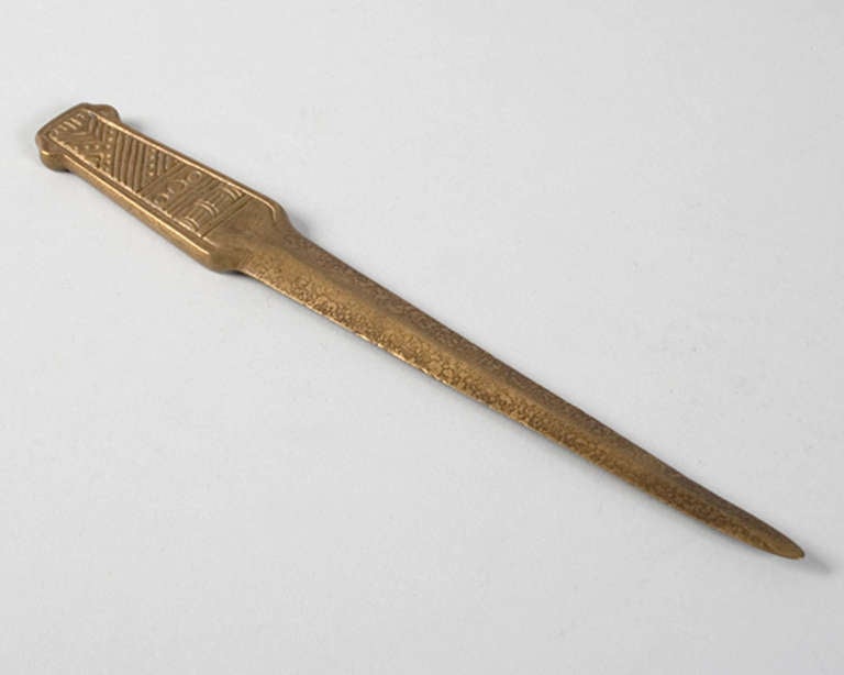 A Tiffany Studios New York bronze “American Indian” Letter Knife. Circa 1910. 

A similar letter knife is pictured in: Tiffany Desk Treasures: A Collector’s Guide, by George A. Kemeny and Donald Miller, New York: Hudson Hills Press, 2002, p. 55,
