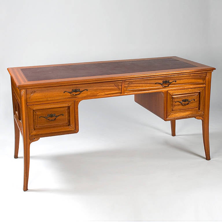 A French Art Nouveau desk by Tony Selmersheim, in rosewood featuring four drawers with bronze floral pulls. 

(MG #10317)