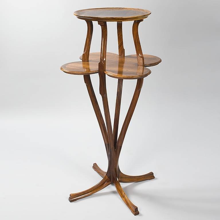 A French Art Nouveau rosewood two-tiered pedestal by Anthony Selmersheim. While the top tier is circular, the lower shelf has four symmetric lobes. The four supports are sinuous and carved, circa 1902.

 