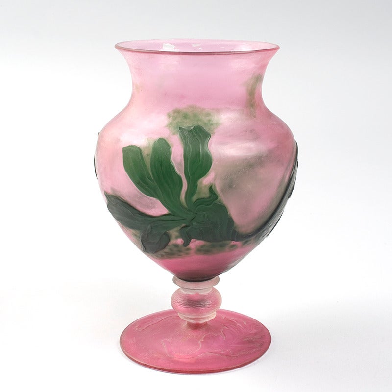A French Art Nouveau cameo glass vase by Daum, decorated with deeply wheel-carved green flowers on rose and pink ground, with applied foot, circa 1900.

A vase with similar decoration is pictured in: Daum Nancy III, by Katharina Büttiker, Zurich: