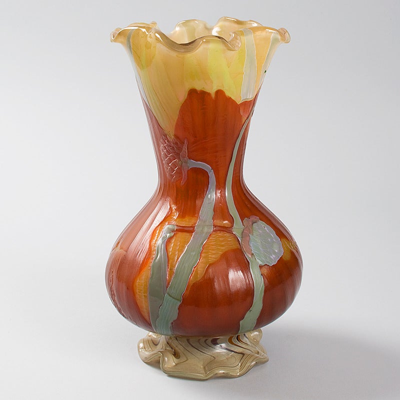 A French Art Nouveau “Marquetry” cameo glass vase by Emile Gallé, featuring magnolia blossoms in carved marquetry glass against a reddish and cream ground, with ruffled top and foot. Circa 1900. The vase was exhibited at the Paris 1900 World
