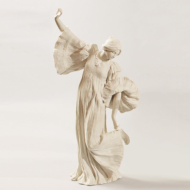 A French Art Nouveau bisque ceramic figural sculpture by Agathon Le?onard, featuring a woman adjusting her sandal with her left hand. Titled “Danseuse au Cothurne” from “Le jeu de l’e?charpe.” This figure is one of the “la danse” (the dance) set,