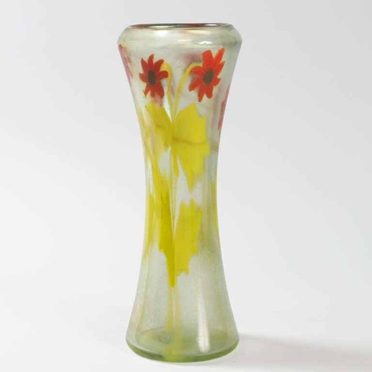 A Tiffany Studios New York Paperweight vase in a floral motif, featuring a band of red flowers with abundant greens stems against a transparent ground. Circa 1900.<br />
<br />
A similar vase is pictured in: Tiffany Favrile Glass and the Quest of