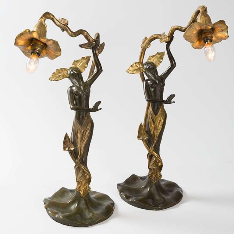 A pair of French Art Nouveau illuminated gilt and patinated bronze femmes-fleur by Helene Sibeud, circa 1900.

Signed, 