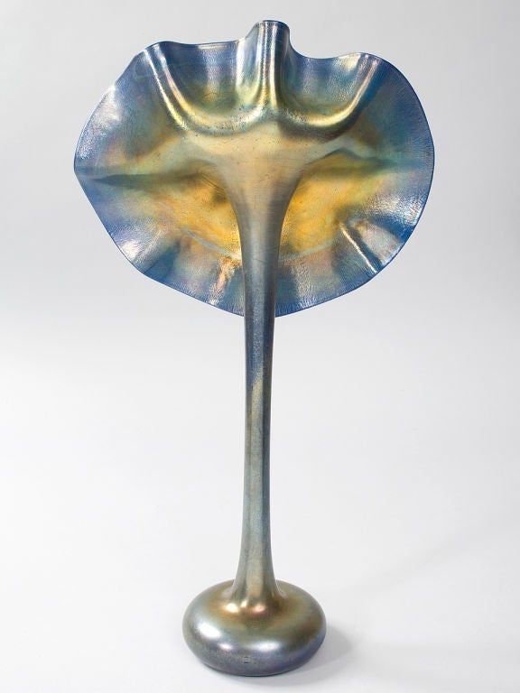 A Tiffany Studios New York glass “Jack-in-the-Pulpit” vase, featuring iridescent blue with gold and purple highlights. The “Jack-in-the-Pulpit” vase was rarely made in blue glass.
(MG Inventory # T11955)
