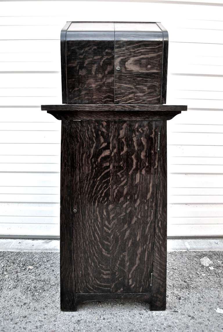 A rare Arts and Crafts/ Crafman bar, the color is even darker in person and also the patina is much nicer in person, it has it original poker chips and iced cooler and hardweare , you have a glass rack, and plenty more, made of tiger oak wood

ALL