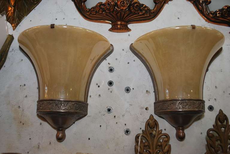 A beautiful pair of Art deco sconces, the glass is natural, it look like they is patterns on the glass, but it is actually the reflection of some other lighting, the glass is much more  beautiful in person.

We have over three thousand antique