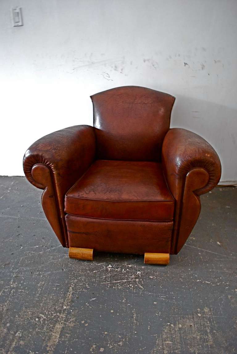 A beautiful and elegant French Art Deco leather club chair, 
the feet are very different , very deco, the patina of the leather is so much nicer in person, I have hundred of French club chairs,
but never see these kind of feet, the price is firm