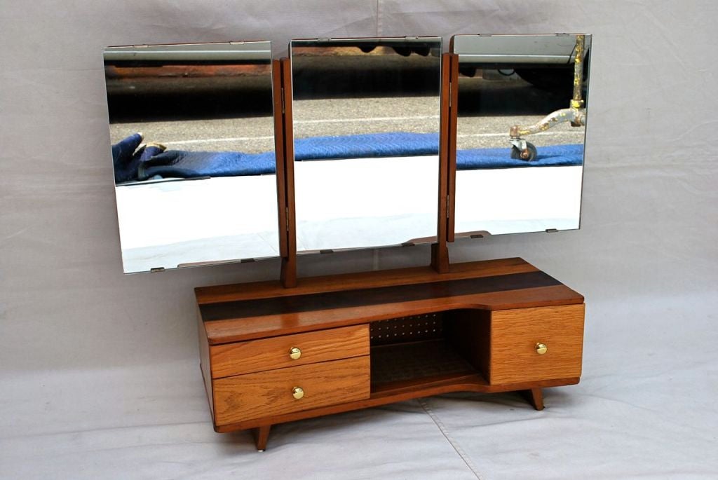 A very nice and unusual small vanity, the darker part of the wood case in the center  is metal, it is very elegant, the length of the mirror is 32 inch, the  length of the wood case is 24 inch

ALL SALES ARE FINAL, STORE CREDIT OR EXCHANGE ONLY