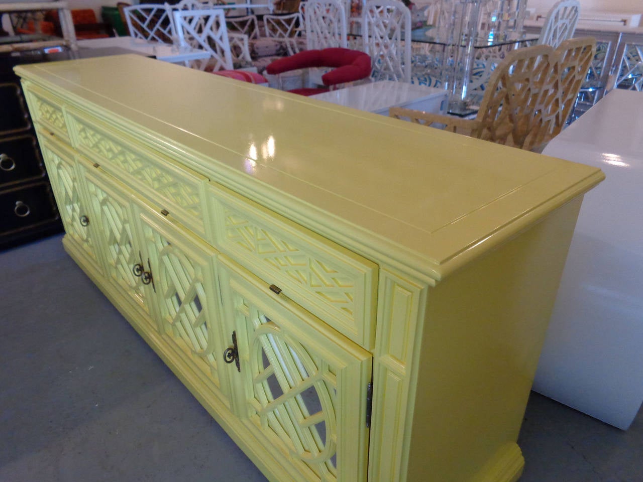 Hollywood Regency style Fretwork dresser or credenza in nice as found vintage condition. There are minor imperfections to newly lacquered finish. Benjamin Moore, delightfully yellow.