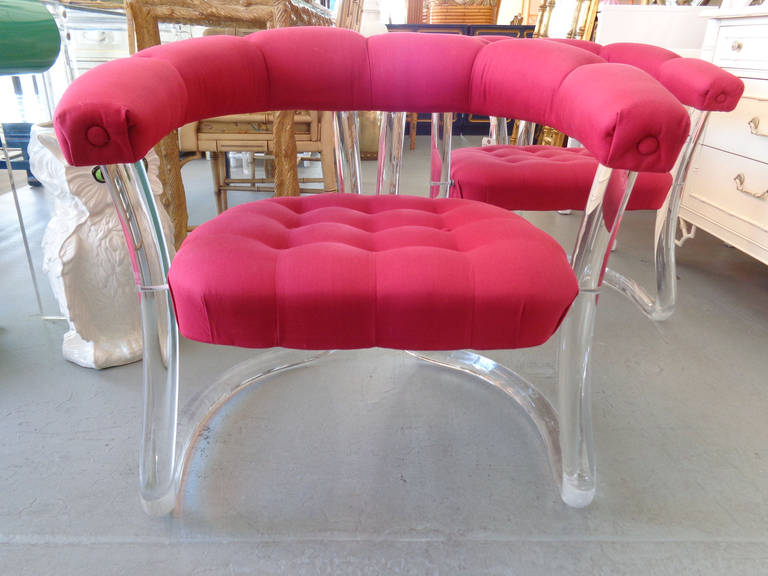 A pair of Lucite tufted chairs in good as found vintage condition. Some crazing at the base bends and scuffs to the bottom. Minor wear and staining to the as found upholstery.