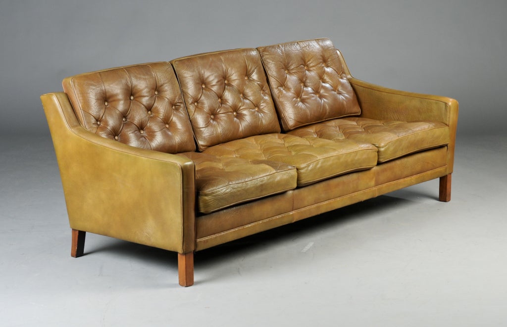 Tufted patinaed 3 seater, leather Danish sofa with mahogony legs