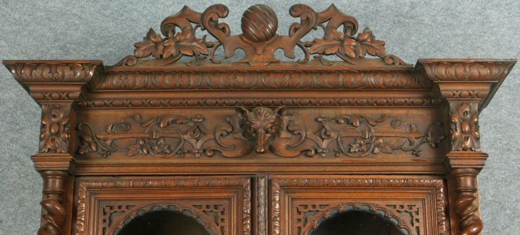 A French Hunting Style Buffet Server China Hutch Display Cabinet in oak with double barley twist columns and exceptional carvings of fruit and foliage on the lower cabinet doors