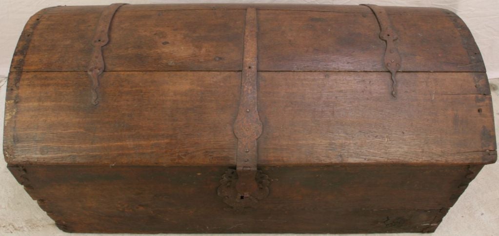 A charming French Country Trunk in oak with original iron decorative hardware and dovetail joints