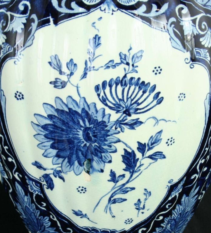 Item #: 11-483-0<br />
<br />
Antique Blue Delft Transferware Ginger Jar Vase Lion<br />
<br />
Comment: <br />
<br />
Nice old one with vibrant color and lion ornament on top.<br />
<br />
Mark: Petrus Regout<br />
<br />
<br />
<br
