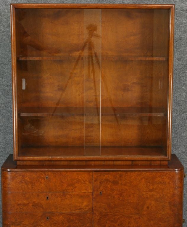 A French Art Deco China Curio Cabinet Vitrine in burled walnut veneer with sliding glass doors