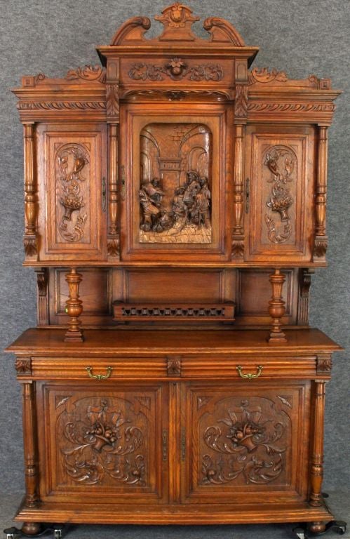 A charming Antique Renaissance-Style Figural Buffet Sideboard Server from France in oak with carved figures of musicians playing music in a pub.