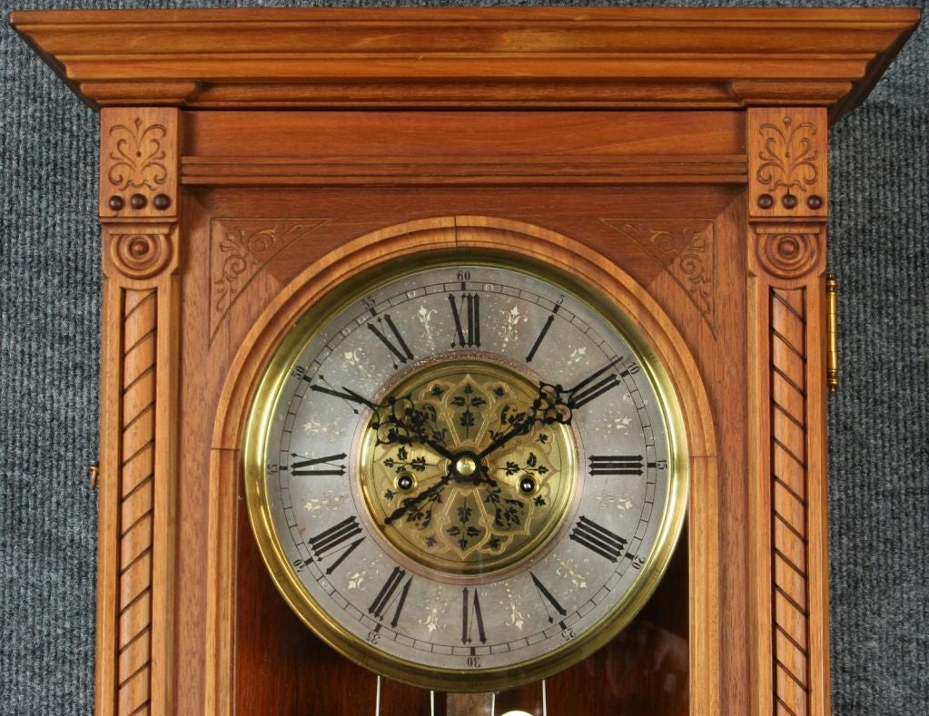 A German Double Weight Regulator Wall Clock in the Viennese style dating to 1892 with a walnut case and attractively decorated dial and pendulum. The works and pendulum are stamped with the Lenzkirch mark, recognized as one of the best of the Black