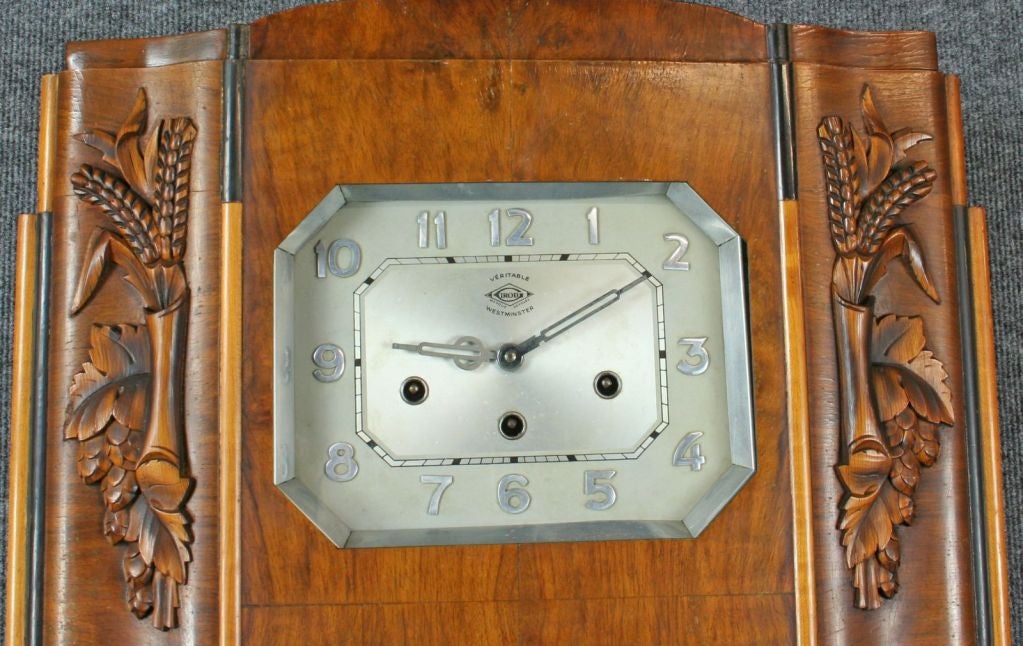 An unusual large French Regulator Wall Clock in the Art Deco style dating to 1920 in a walnut case featuring stylized wheat and grain symbolizing prosperity and the harvest. The dial is stamped with the mark of Girod and indicates that the clock