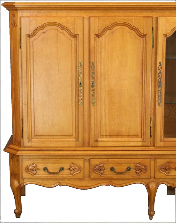 A large vintage French Country Louis XV-Style Buffet China Hutch Cabinet in oak with center glass door for display space.