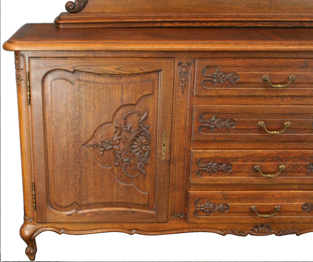 A vintage French Country Louis XV Style Sideboard Buffet Server from France dating to 1930 in oak with attractive decorative plate stand along the back edge, pretty carved doors and drawers, and cabriole legs.