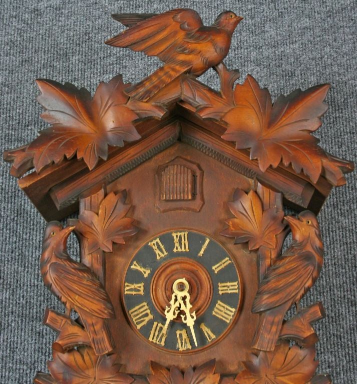 A vintage Black Forest Cuckoo Clock from Germany circa 1950 with a charming motif of carved birds.