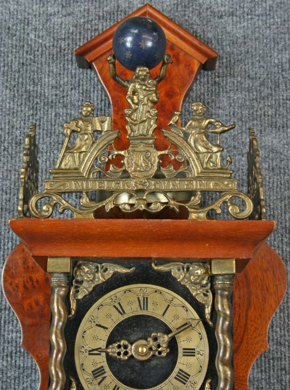 A vintage Zaandam Zaanse Style Pendulum Wall Clock from Holland dating to 1950 in oak and featuring the mythological figure of Atlas carrying the world on his shoulders at the top.