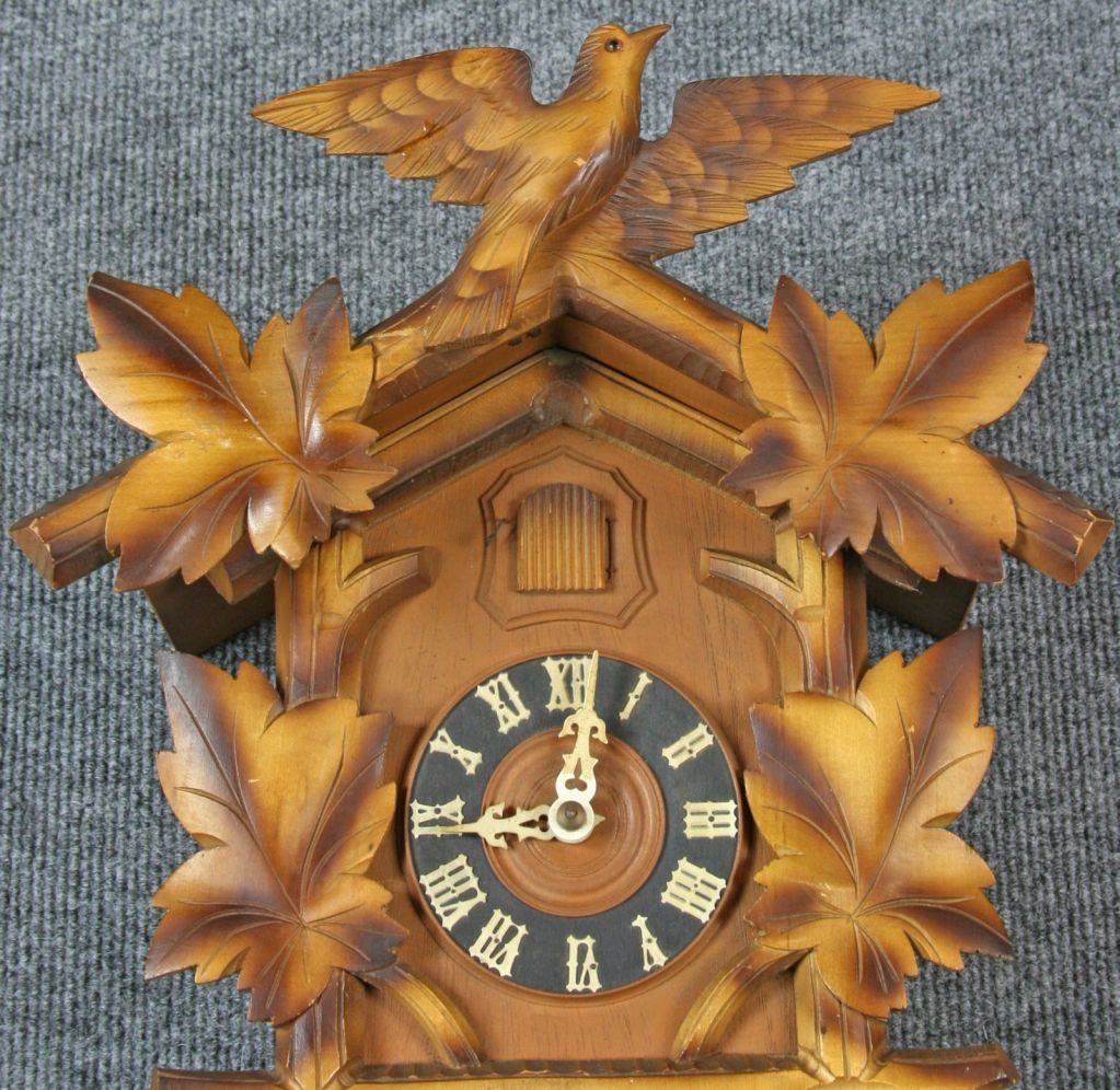 A vintage Black Forest Cuckoo Clock from Germany dating to 1950 with a charming bird motif.
