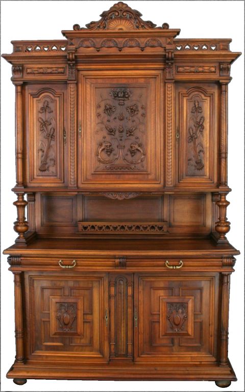 A Henry II Style Buffet Sideboard Hutch from France circa 1900 in walnut featuring beautiful carved irises on the upper cabinet doors.