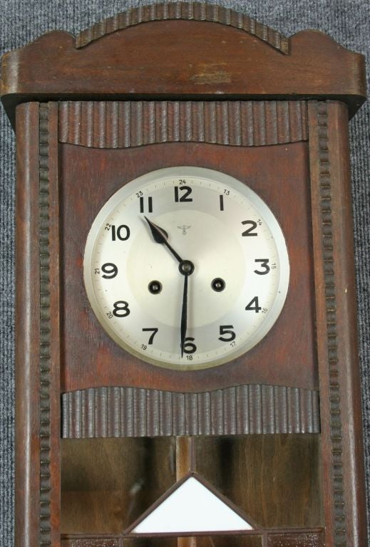 A German Regulator Wall Clock in the Art Deco style with an attractive oak case with a stained glass panel door and marked with the stamp of Mauthe, one of the best German clock manufacturers.
